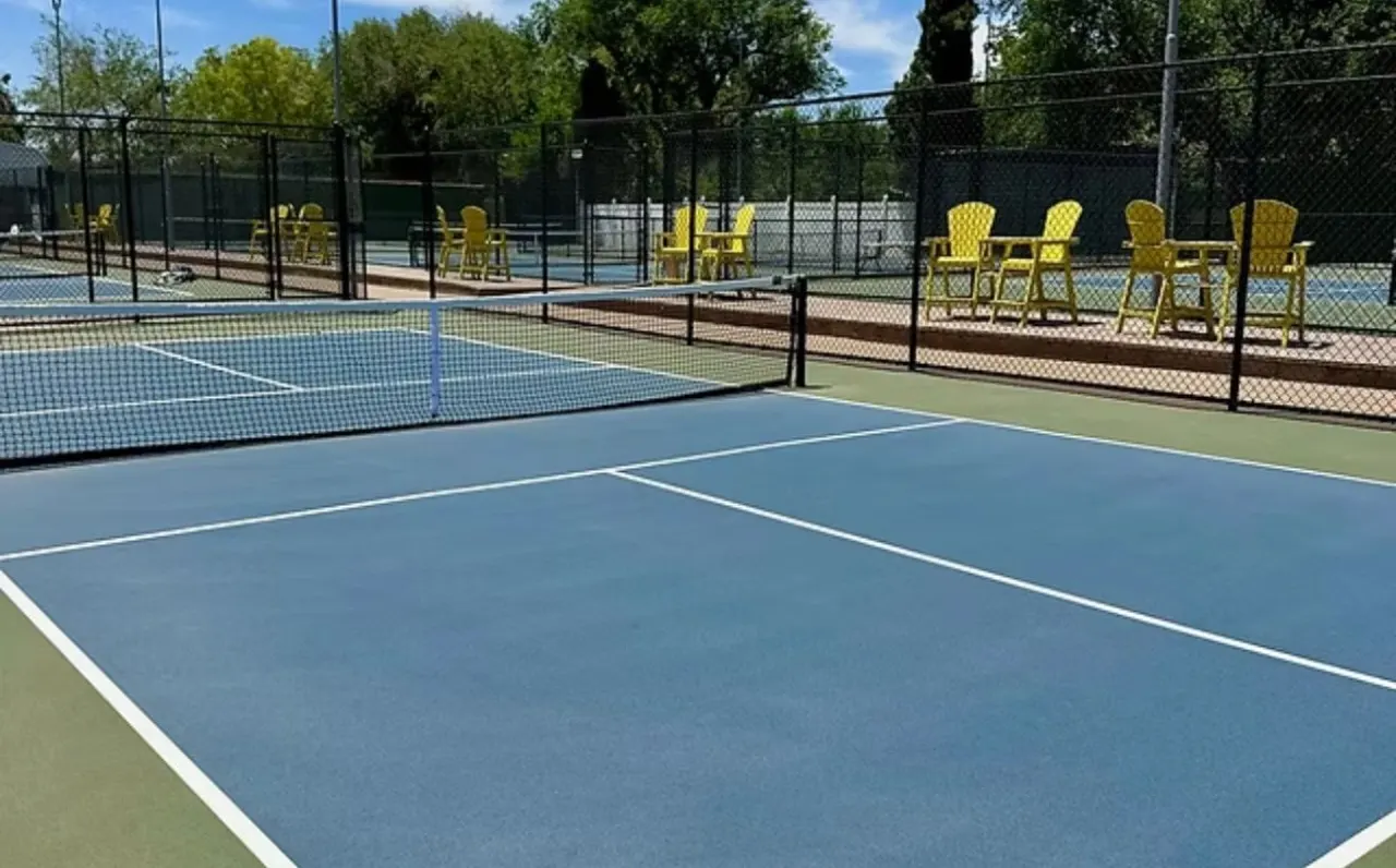 The Pickleball Universe deck: blue courts and yellow high-top chairs